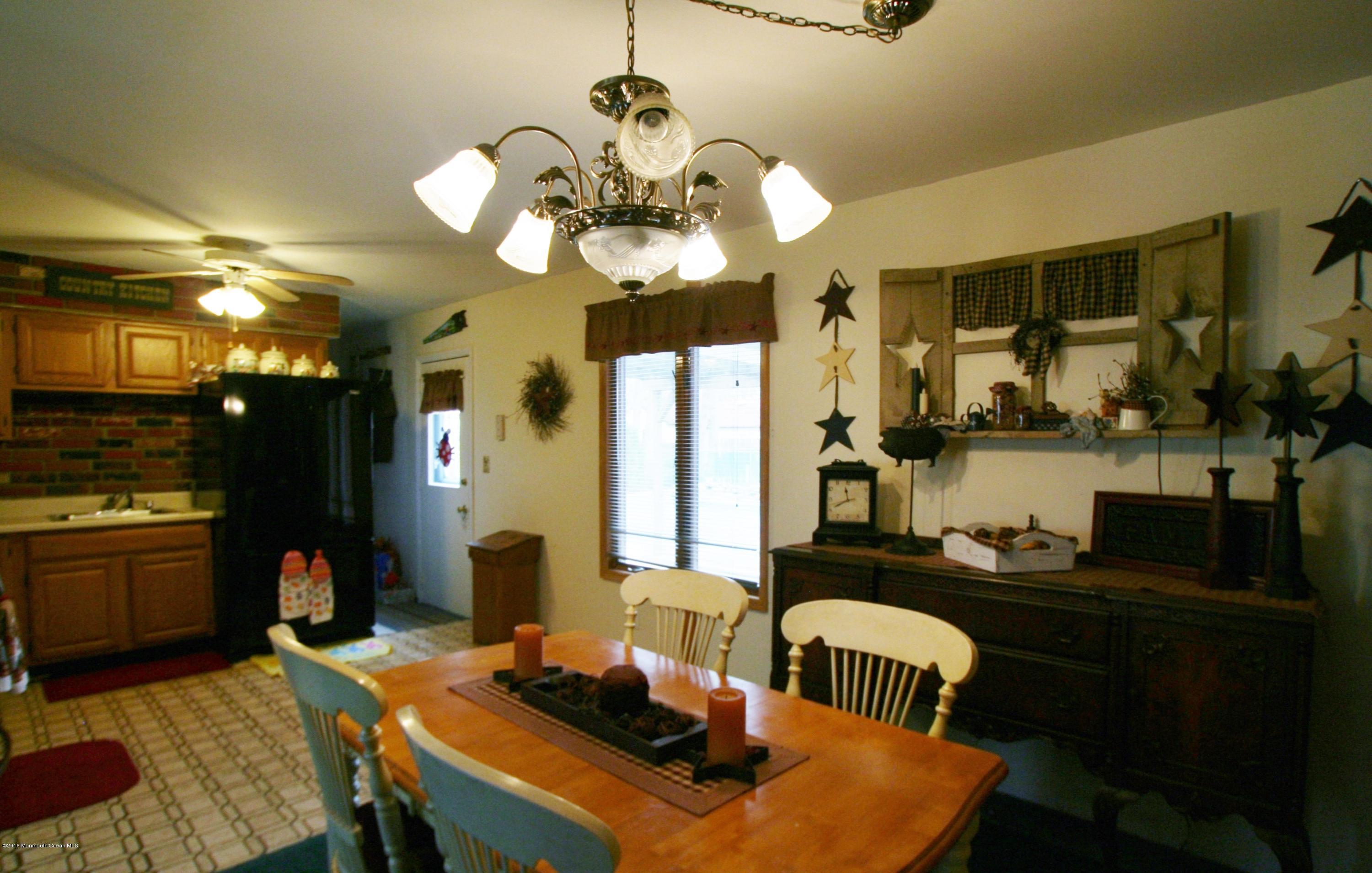 18 Cranmer Road Bayville, NJ 08721 - Photo 13 of 14 a dining room with wooden floor and chandelier