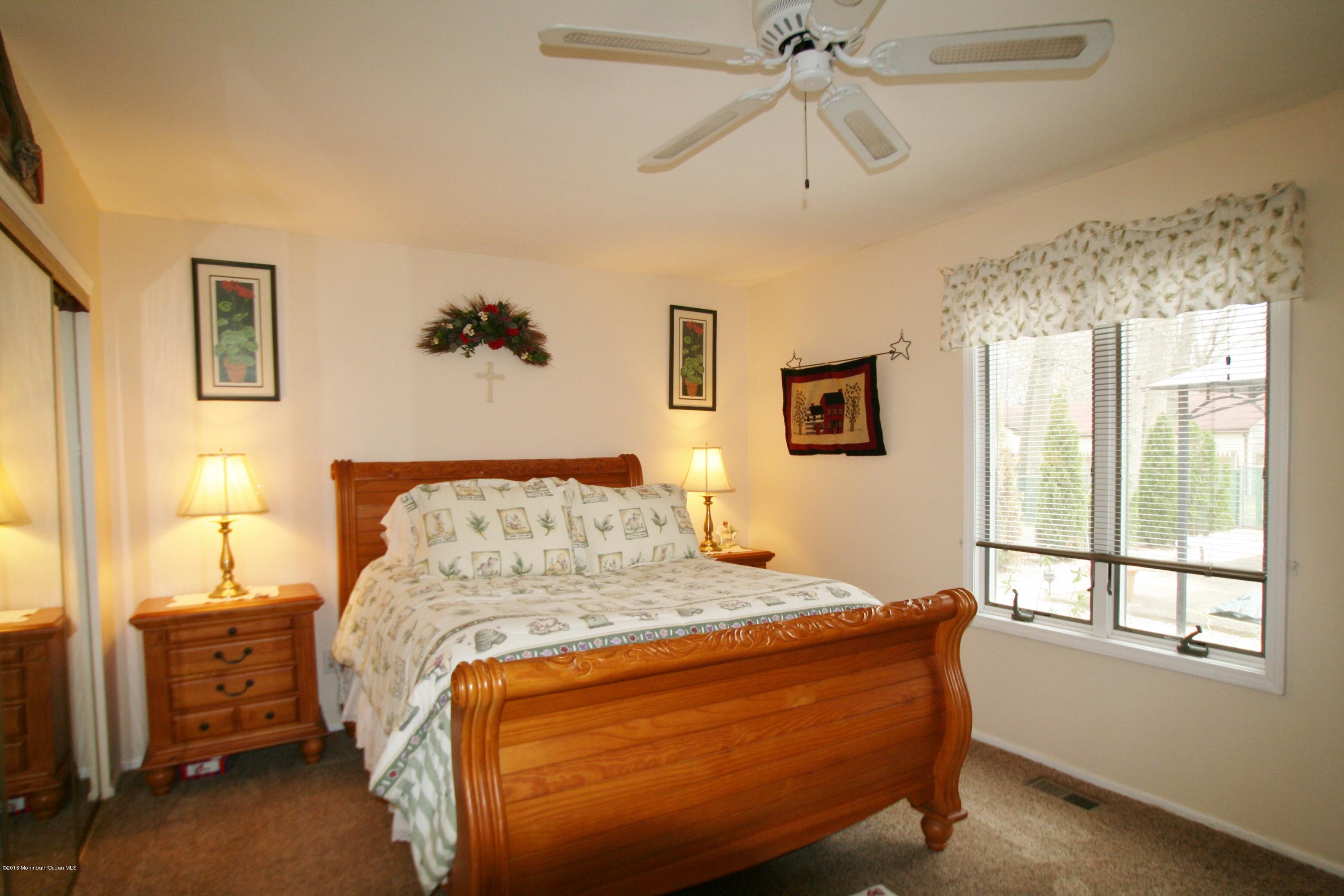 18 Cranmer Road Bayville, NJ 08721 - Photo 7 of 14 a bedroom with a bed and a chandelier