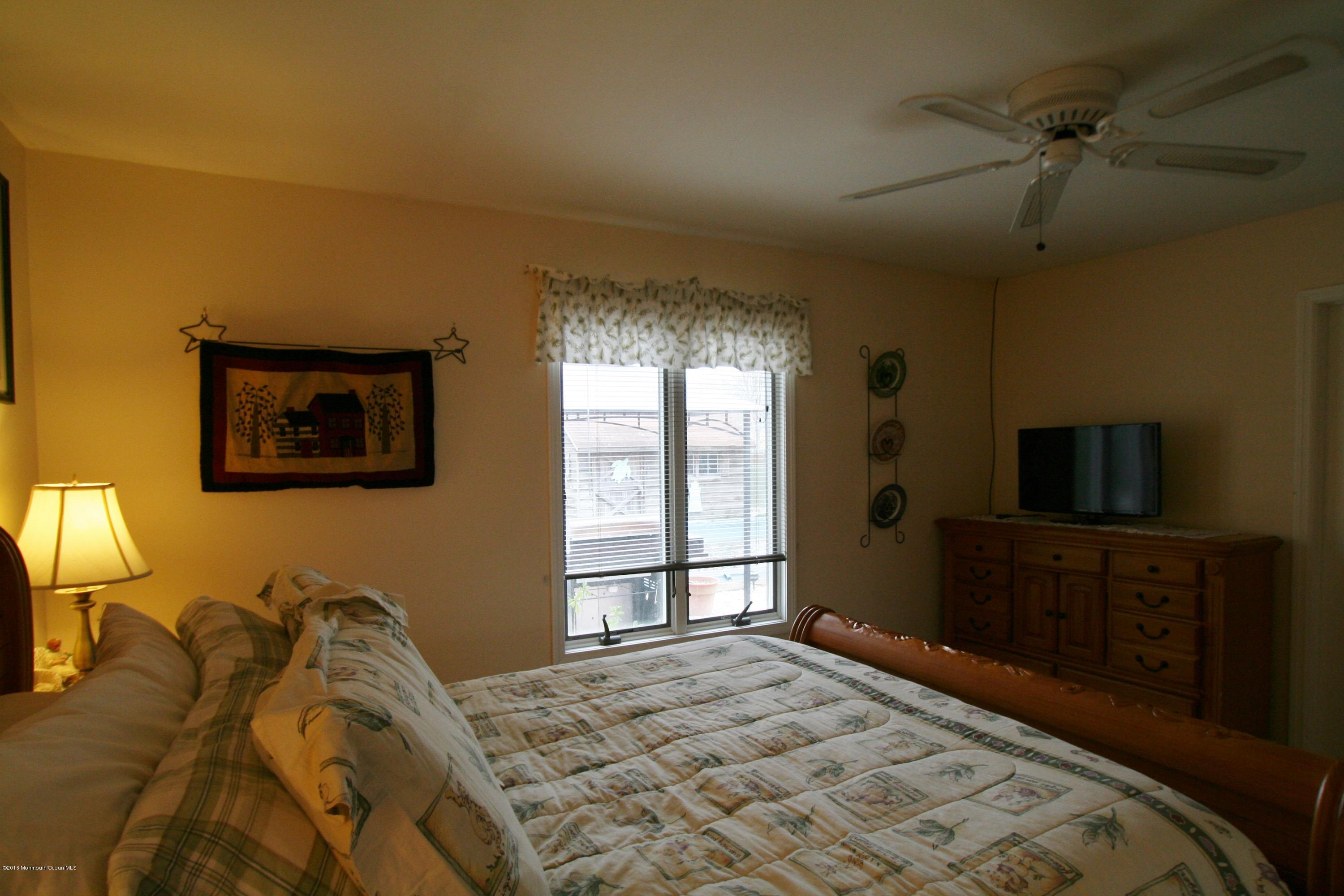 18 Cranmer Road Bayville, NJ 08721 - Photo 9 of 14 a bedroom with a bed and a flat screen tv