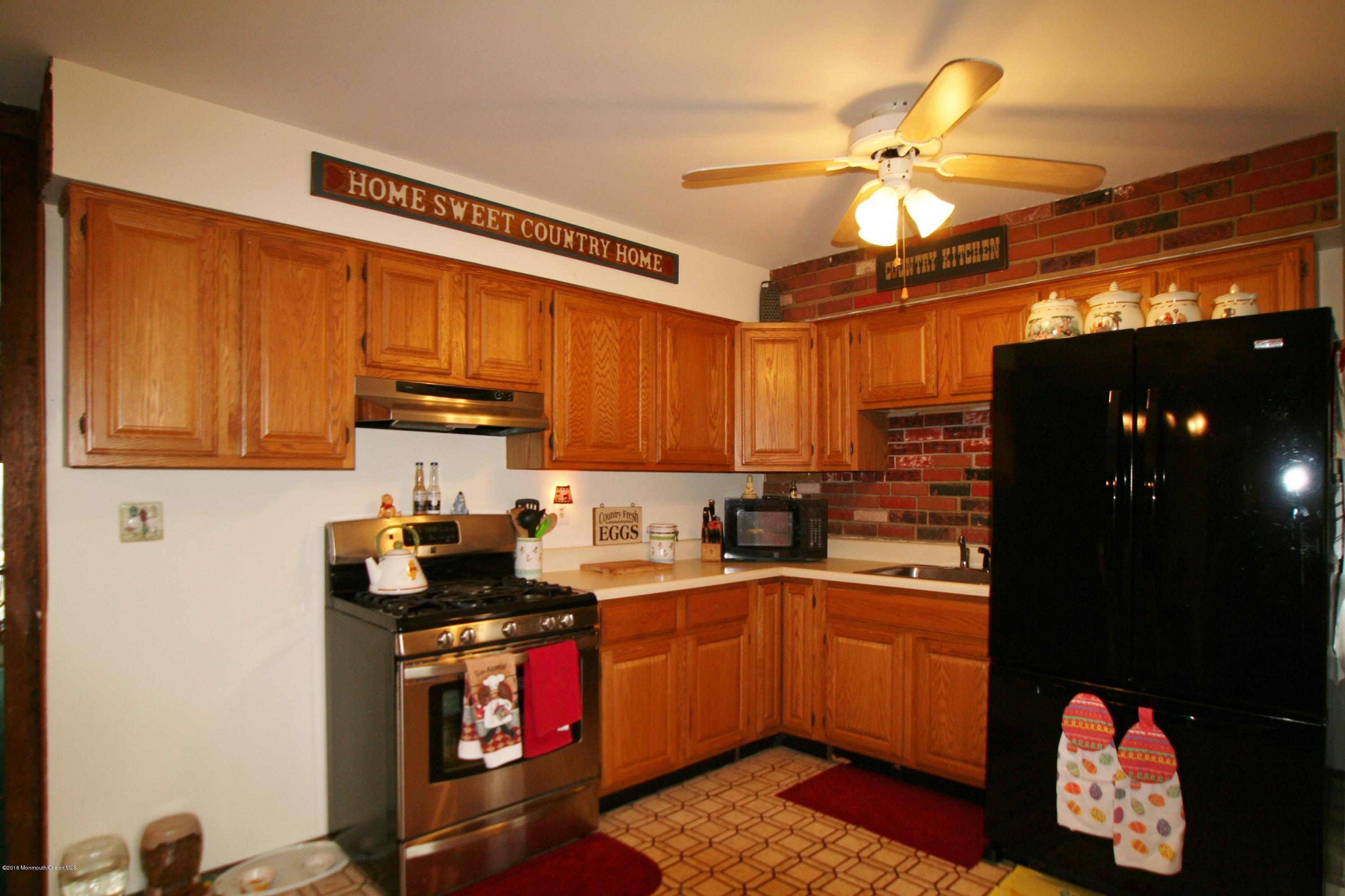 18 Cranmer Road Bayville, NJ 08721 - Photo 10 of 14 a kitchen with granite countertop a sink a stove and cabinets