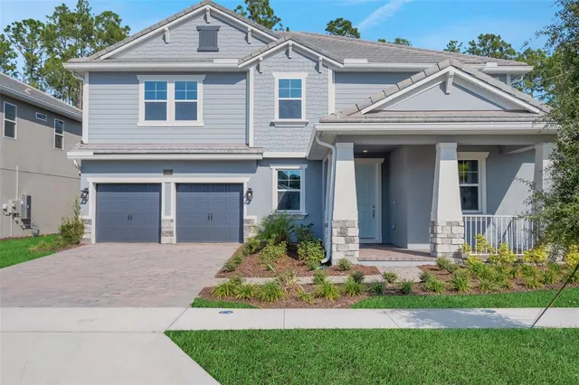 a front view of a house with a garden and plants