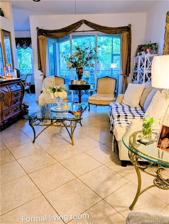 414 Southwest Walking Path, Unit 414 Stuart, FL 34997 - Photo 3 of 15 a living room filled with furniture and a chandelier