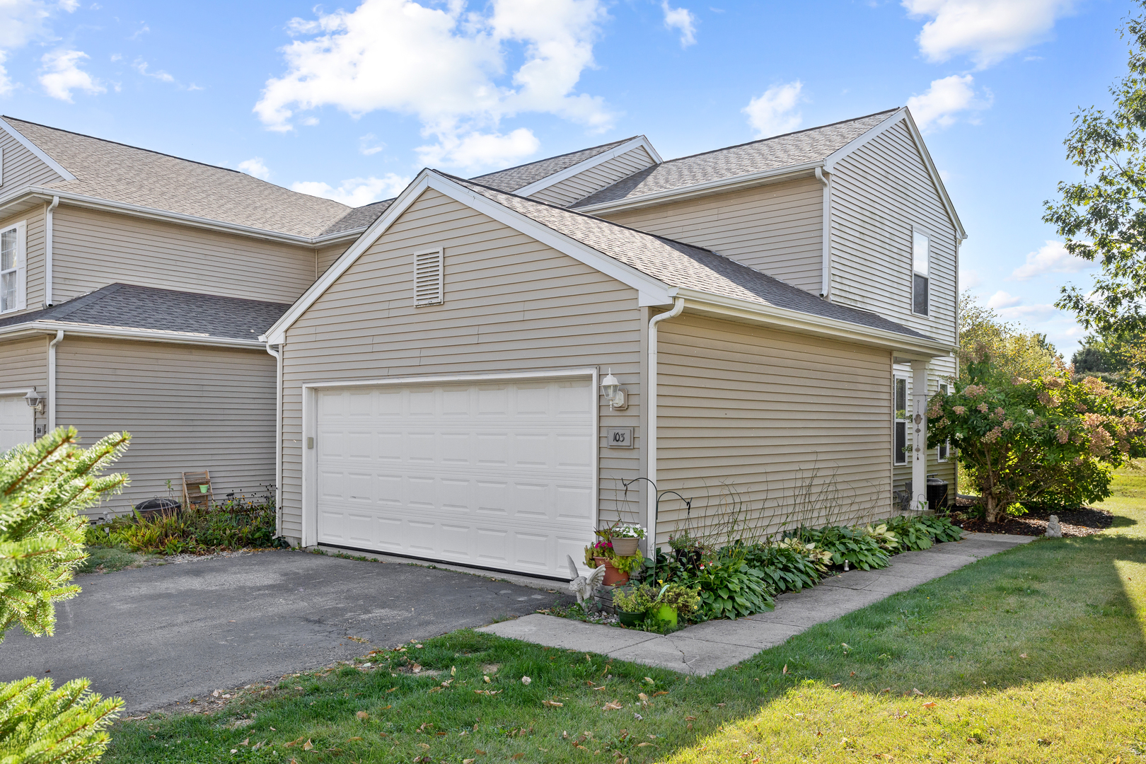 1400 Hunters Ridge Drive, Unit 103 Genoa City, WI 53128 - Photo 1 of 1 a front view of house with a garden