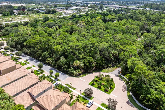 an aerial view of a house with a yard and outdoor seating