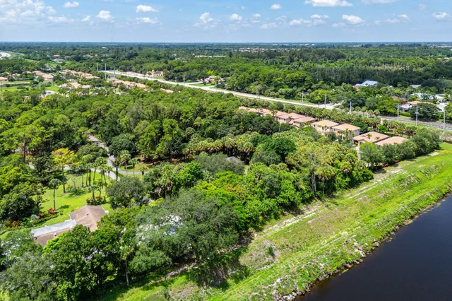 an aerial view of residential houses with outdoor space and lake view