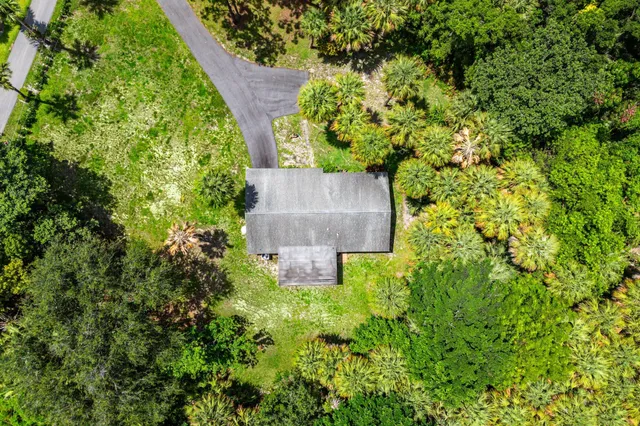 an aerial view of a house with a yard and garden