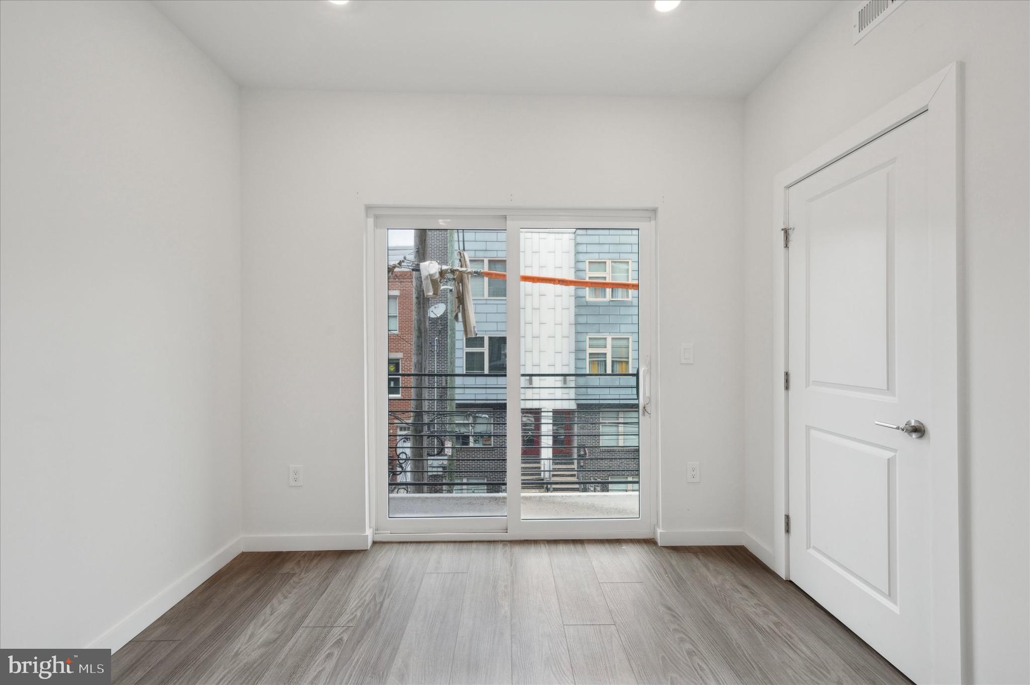 1617-19 Ridge Avenue, Unit C Philadelphia, PA 19130 - Photo 12 of 26 wooden floor in an empty room with a window