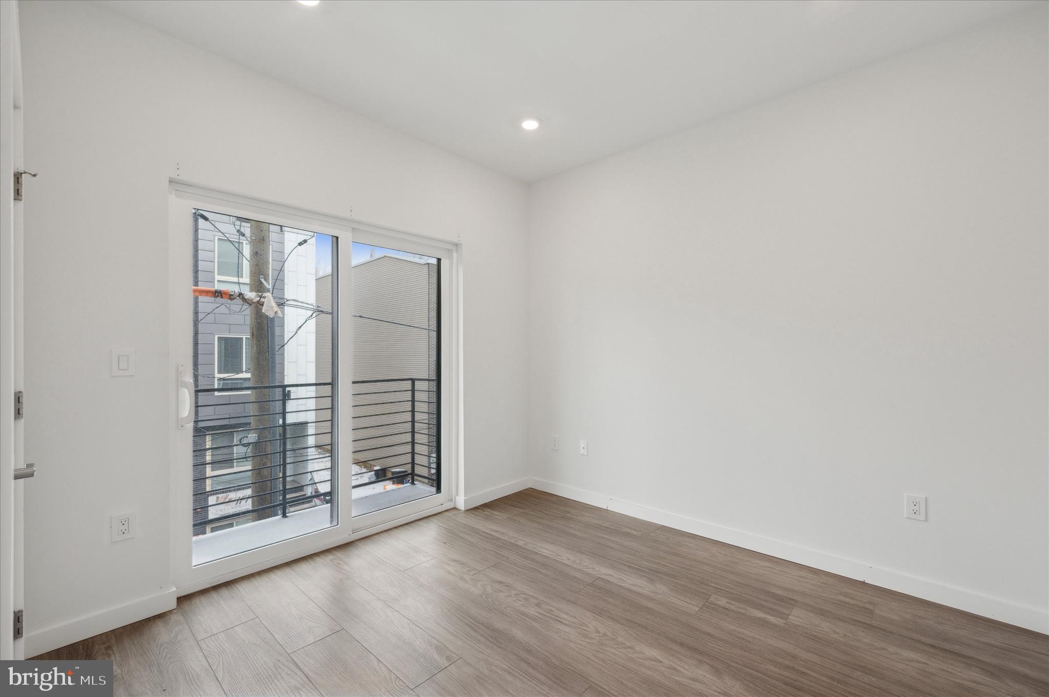 1617-19 Ridge Avenue, Unit C Philadelphia, PA 19130 - Photo 14 of 26 an empty room with wooden floor and windows