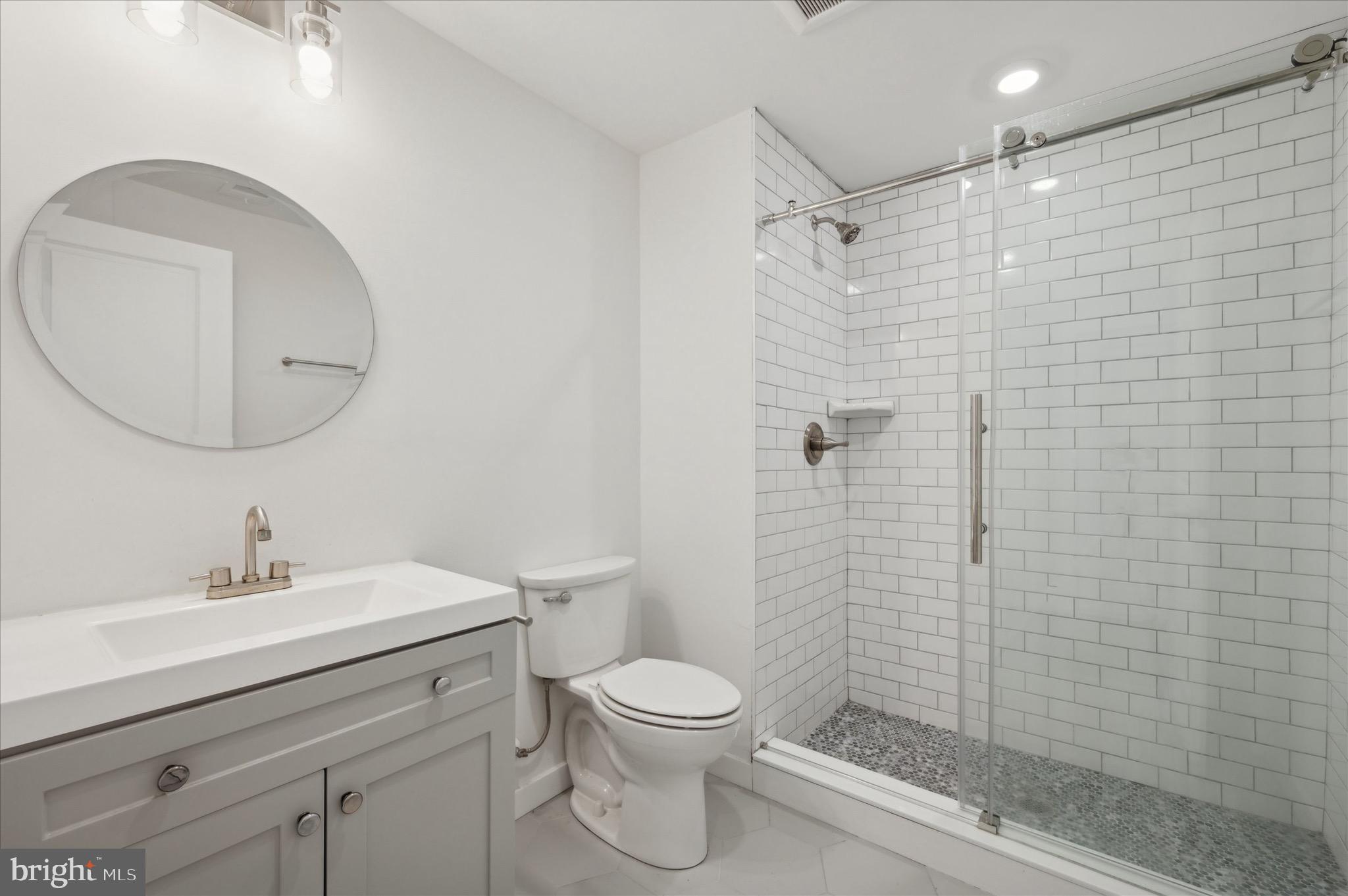 1617-19 Ridge Avenue, Unit C Philadelphia, PA 19130 - Photo 21 of 26 a bathroom with a sink a toilet and shower