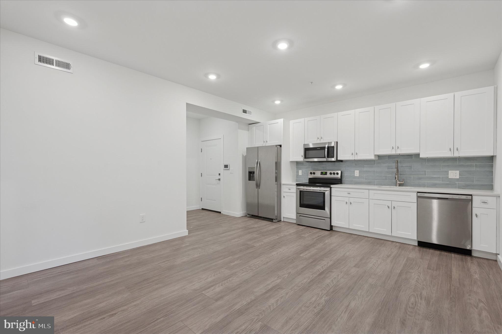 1617-19 Ridge Avenue, Unit C Philadelphia, PA 19130 - Photo 4 of 26 a kitchen with a refrigerator and a stove top oven