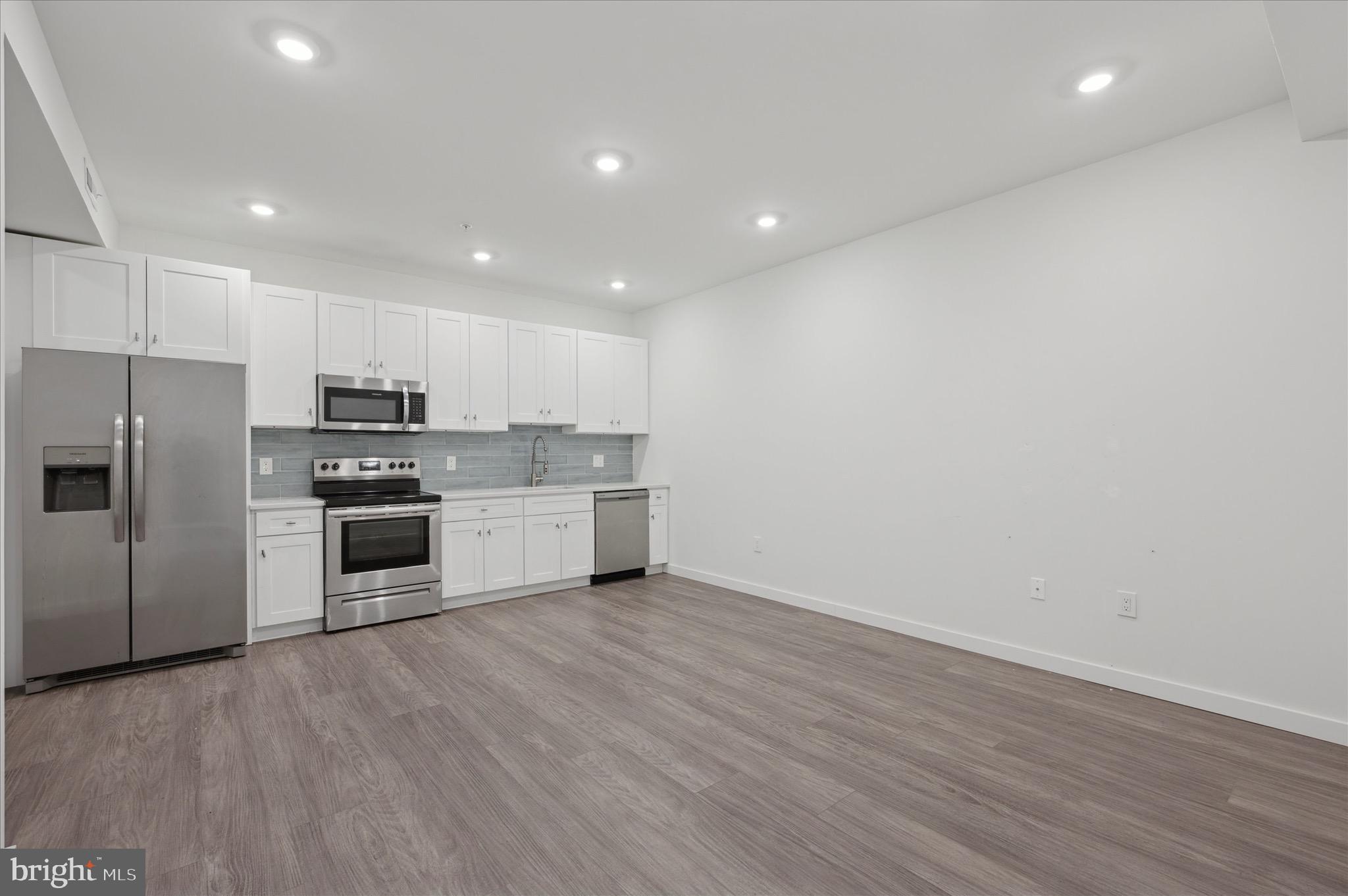 1617-19 Ridge Avenue, Unit C Philadelphia, PA 19130 - Photo 6 of 26 a kitchen with stainless steel appliances a refrigerator and a stove top oven