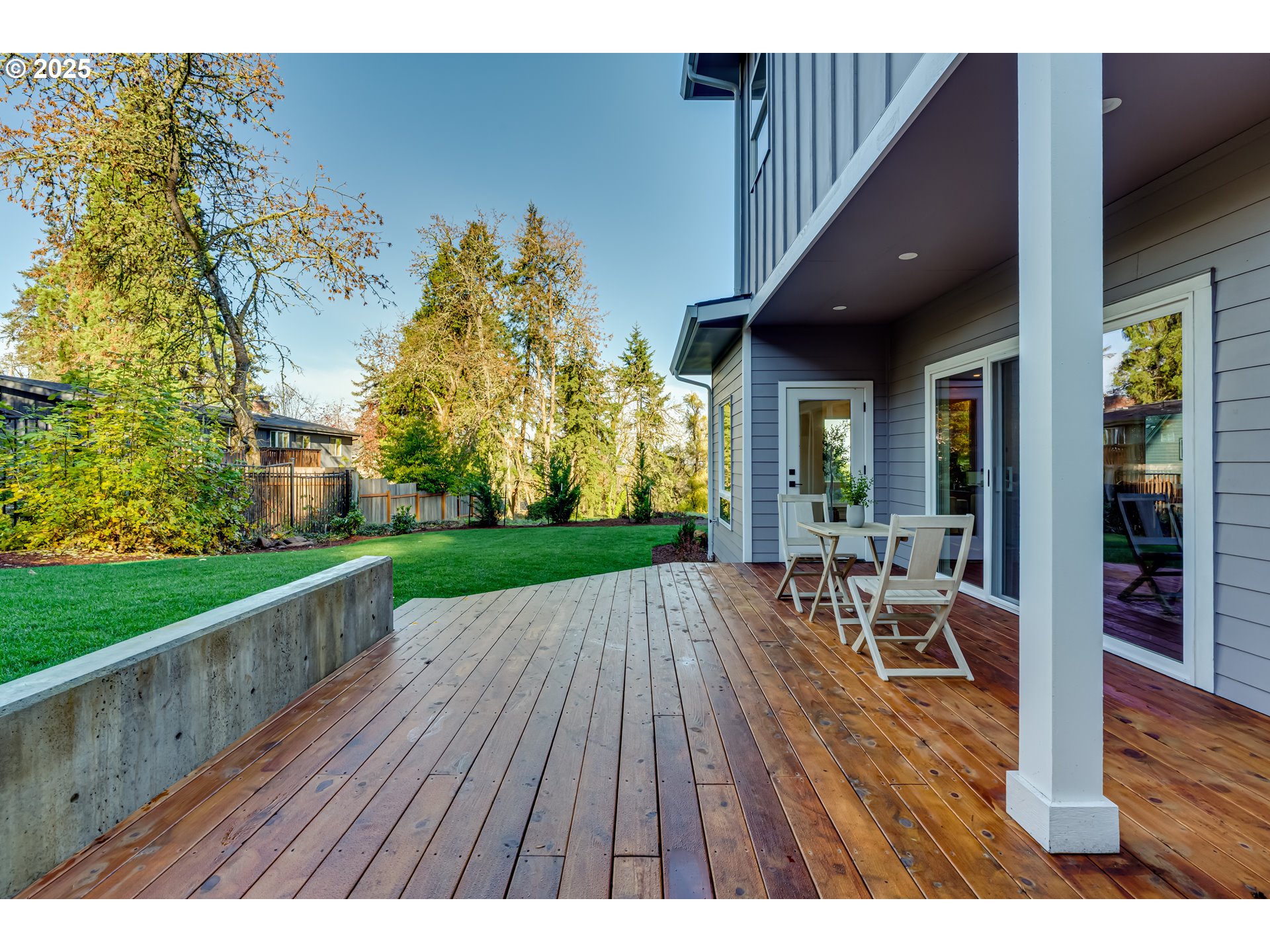 2240 West 25th Place Eugene, OR 97405 - Photo 40 of 48 a view of a patio with table and chairs with wooden floor and fence
