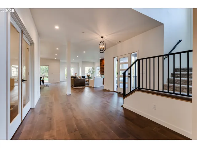 a kitchen with stainless steel appliances kitchen island granite countertop a refrigerator a stove a sink dishwasher with a dining table and chair