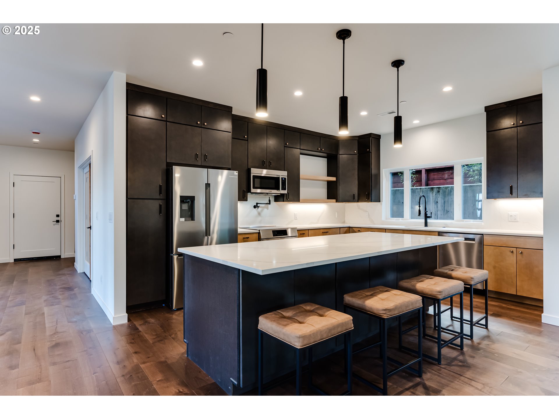 2240 West 25th Place Eugene, OR 97405 - Photo 8 of 48 a kitchen with stainless steel appliances a dining table chairs refrigerator and microwave