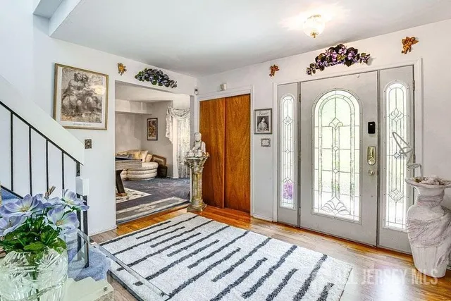 a view of a hallway with wooden floor and windows