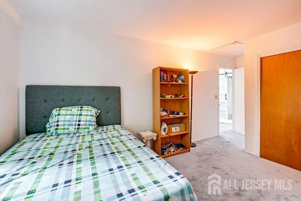 a bedroom with a bed and a television