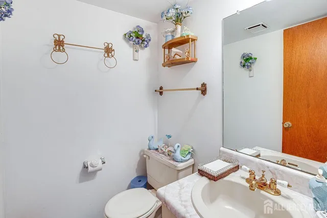 a bathroom with a sink mirror and toilet