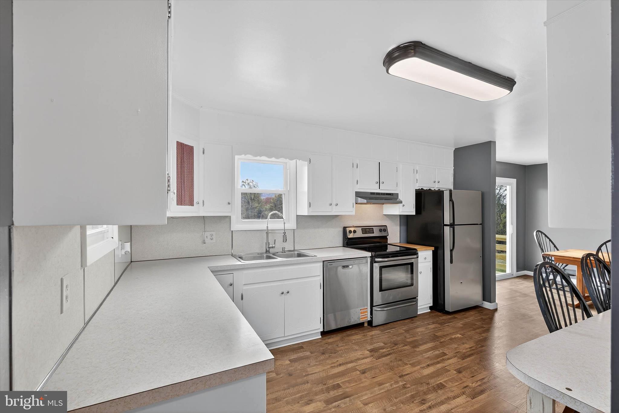 421 Million Dollar Road Halifax, PA 17032 - Photo 8 of 39 a kitchen with a sink a refrigerator and wooden floor