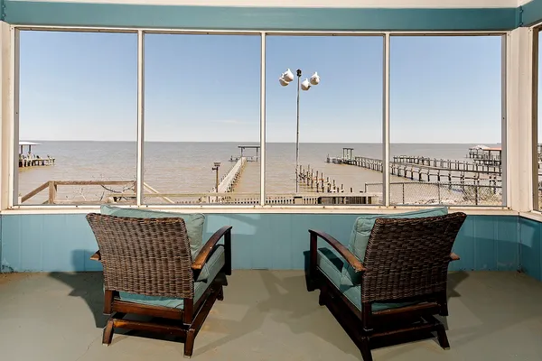 a kitchen with a table chairs and white cabinets