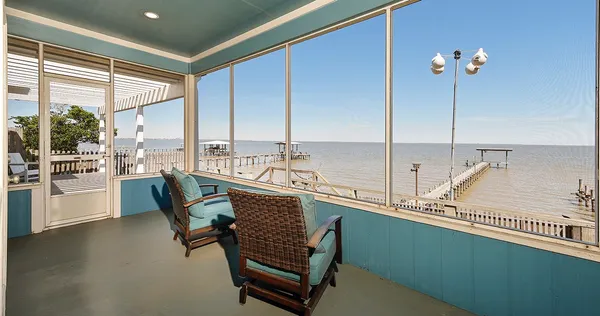 a very nice looking dining room with a large window and furniture