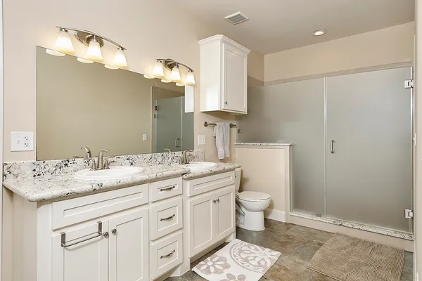a bathroom with a sink a toilet and mirror
