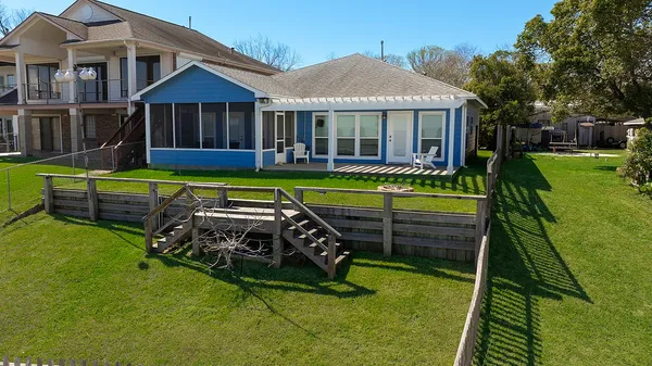 a front view of a house with swimming pool having outdoor seating