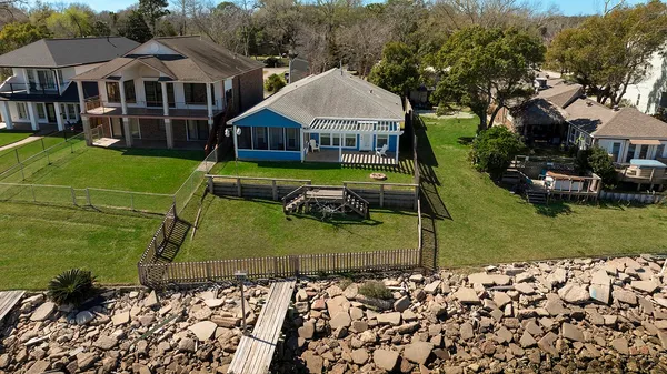 a aerial view of a house with swimming pool and next to a yard