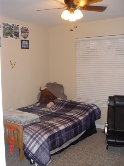 1360 McCool Road Lewisburg, TN 37091 - Photo 16 of 27 a bedroom with a bed and a chandelier