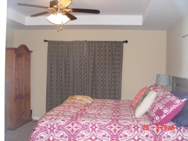 1360 McCool Road Lewisburg, TN 37091 - Photo 18 of 27 a bedroom with a bed and a chandelier
