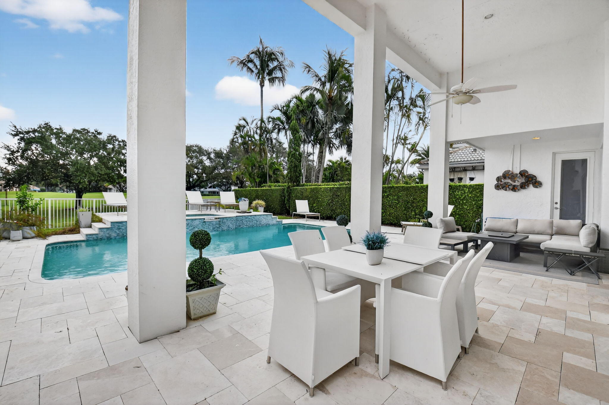 2563 Northwest 63rd Street Boca Raton, FL 33496 - Photo 41 of 65 a view of a patio with couches and table and chairs next to yard