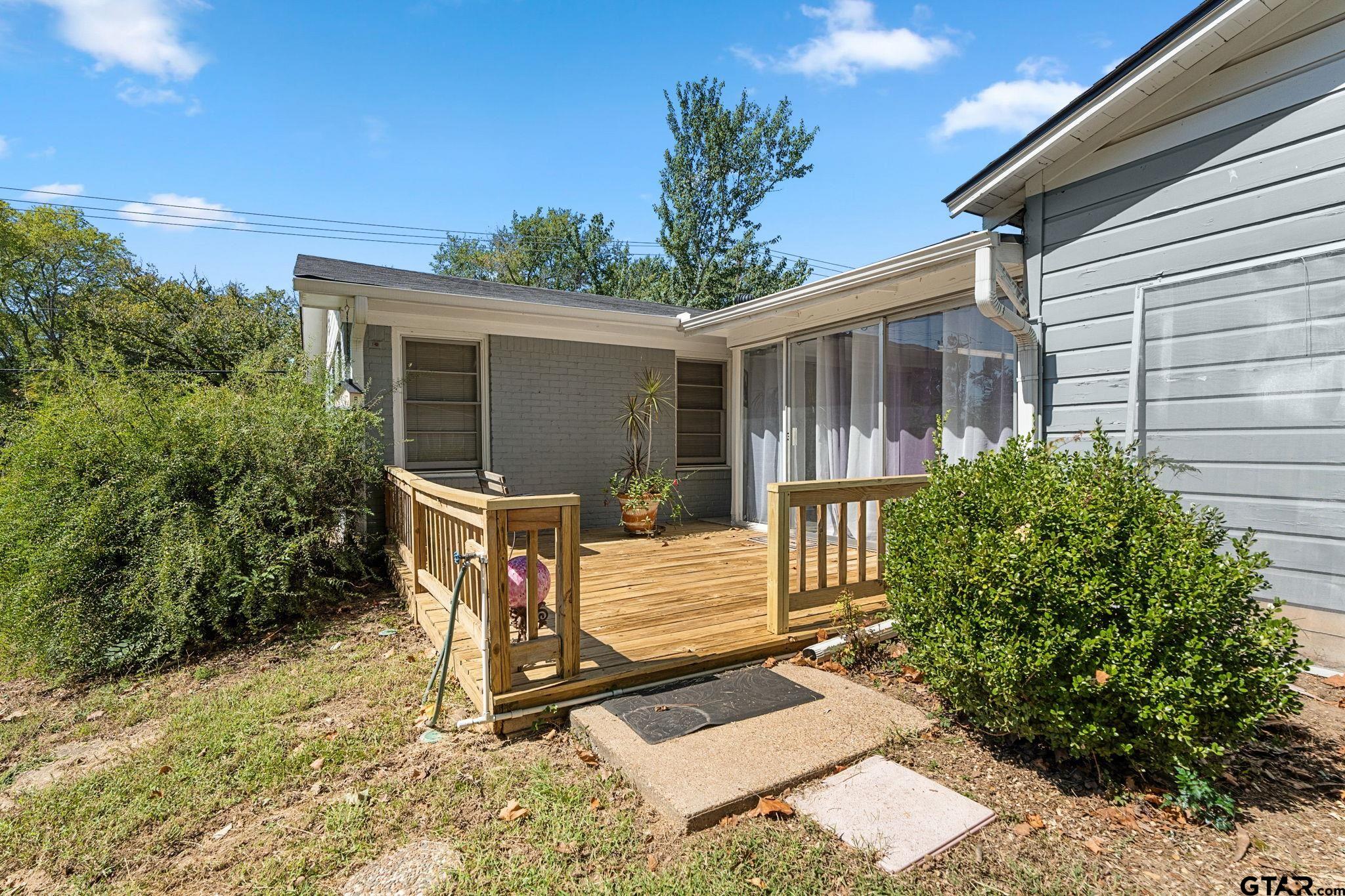 2904 New Copeland Road Tyler, TX 75701 - Photo 26 of 28 a view of backyard with a chair and potted plants