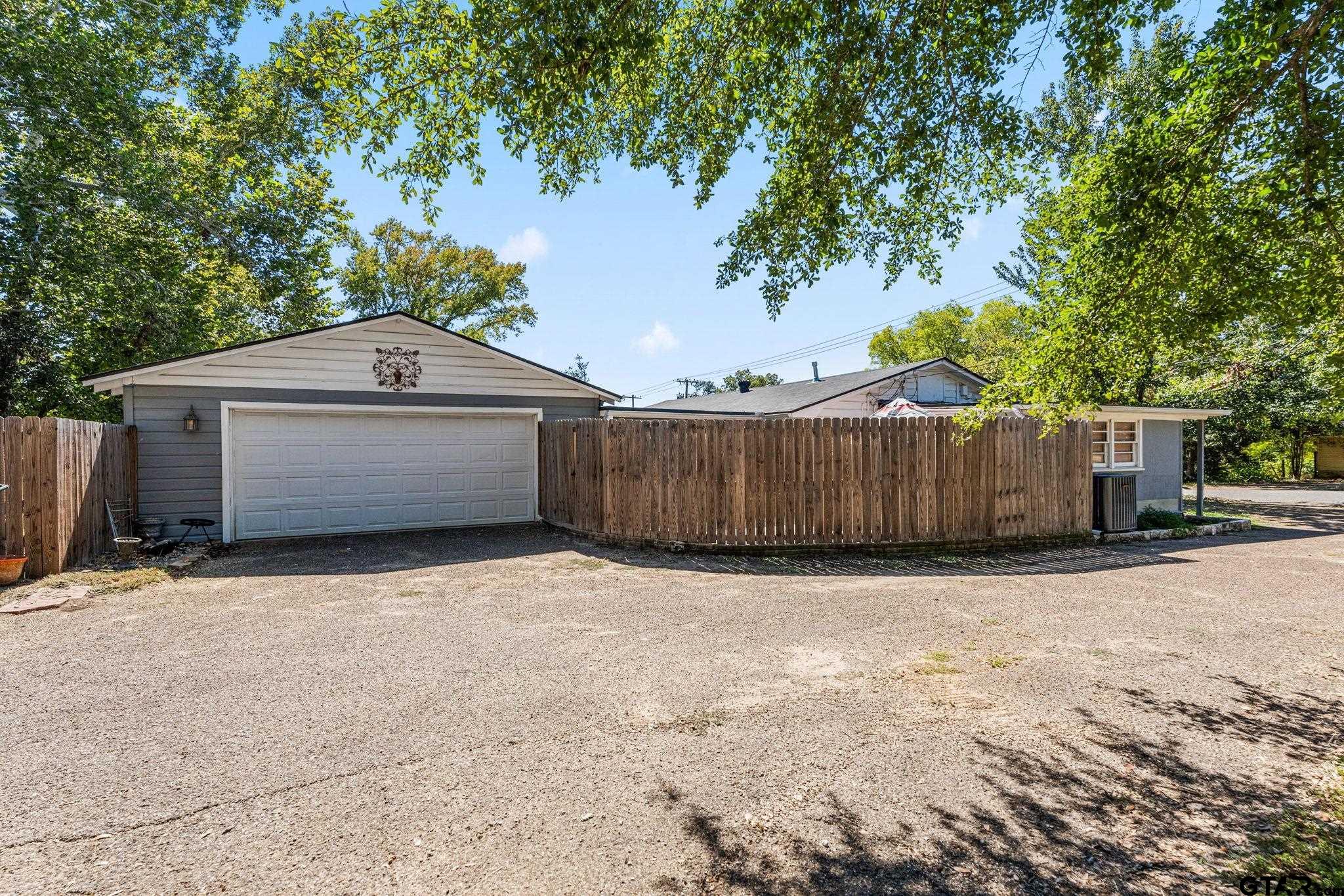 2904 New Copeland Road Tyler, TX 75701 - Photo 28 of 28 a front view of a house with a yard and garage