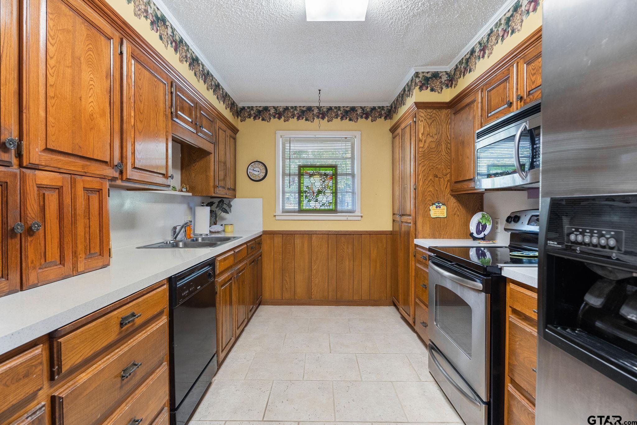 2904 New Copeland Road Tyler, TX 75701 - Photo 7 of 28 a kitchen with stainless steel appliances granite countertop a stove and a sink