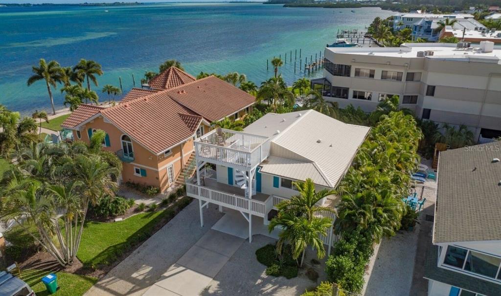 113 8th Street South Bradenton Beach, FL 34217 - Photo 1 of 35 an aerial view of multiple houses with a yard