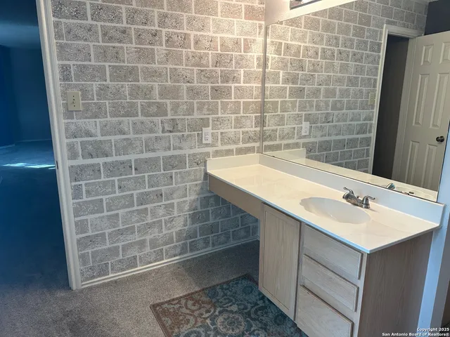 a bathroom with a sink a toilet and a mirror