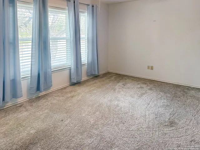 a view of an empty room and a window