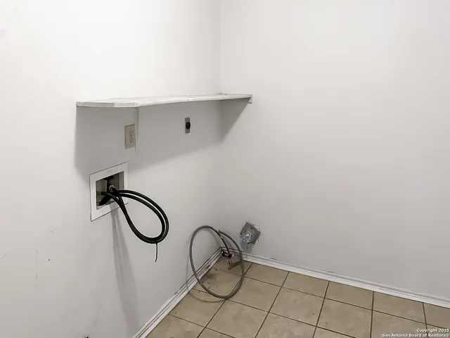 a bathroom with a granite countertop window and a fan
