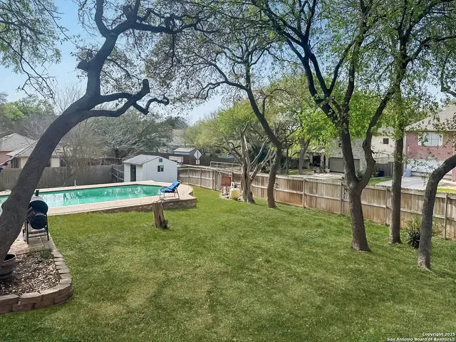 a view of a house with a yard and sitting area