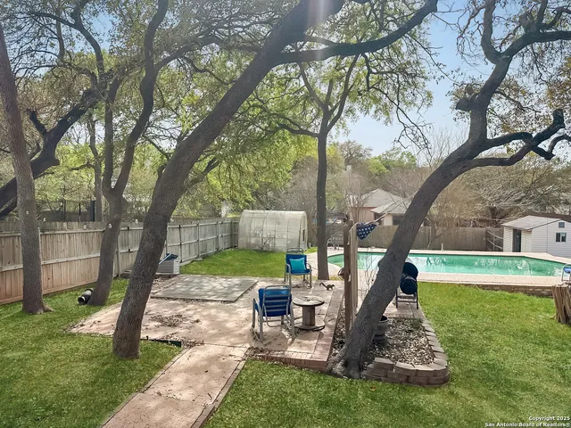 a view of a house with a yard and sitting area