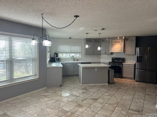 a kitchen with a refrigerator and a sink