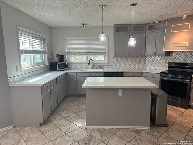 a kitchen with a sink stove and cabinets