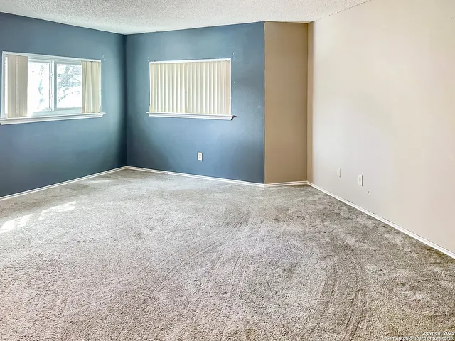 a view of empty room with windows