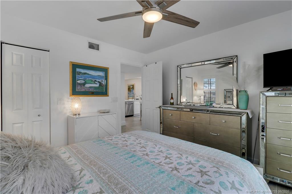 1001 Keystone Drive, Unit A Jupiter, FL 33458 - Photo 16 of 30 a bedroom with a bed and a flat screen tv