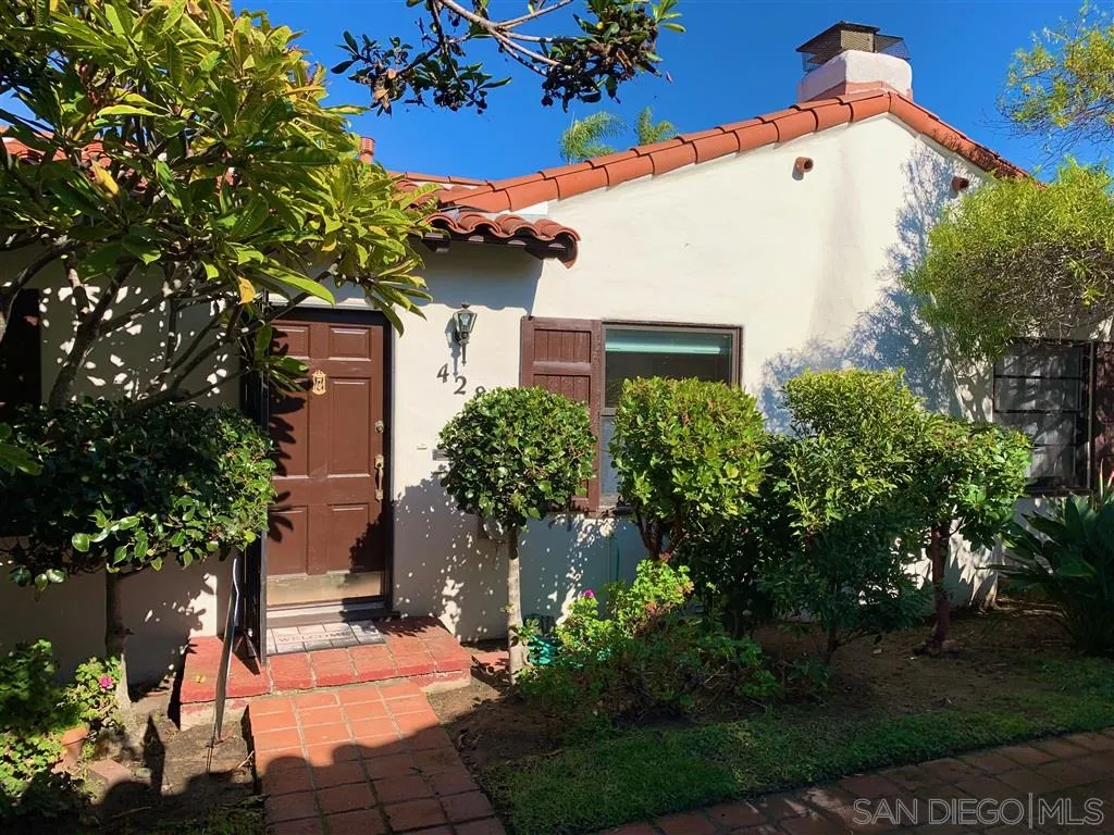 428 G Avenue Coronado, CA 92118 - Photo 2 of 18 a view of a white house with a yard and potted plants