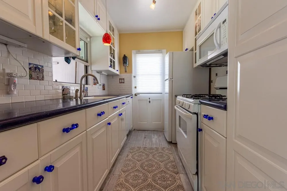 428 G Avenue Coronado, CA 92118 - Photo 4 of 18 a utility room with stainless steel appliances washer and dryer