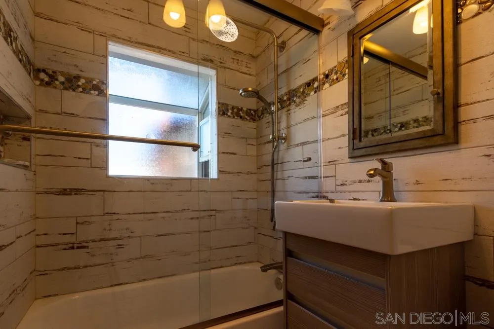 428 G Avenue Coronado, CA 92118 - Photo 7 of 18 a bathroom with a sink and a mirror