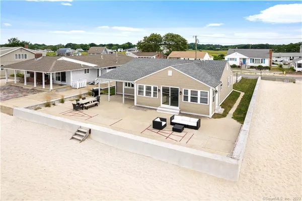 an aerial view of a house with swimming pool and mountains