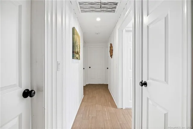 a view of a room with wooden floor