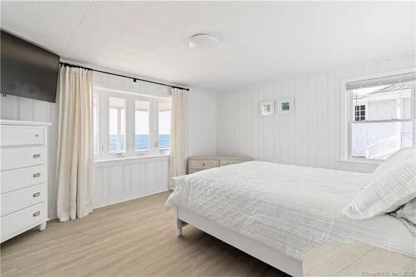a bedroom with a bed and a television