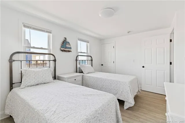 a bedroom with two beds and a window